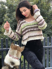 Model wearing Coastline's Cropped Multicolor Sweater with black trousers, posing outdoors beside a dog.