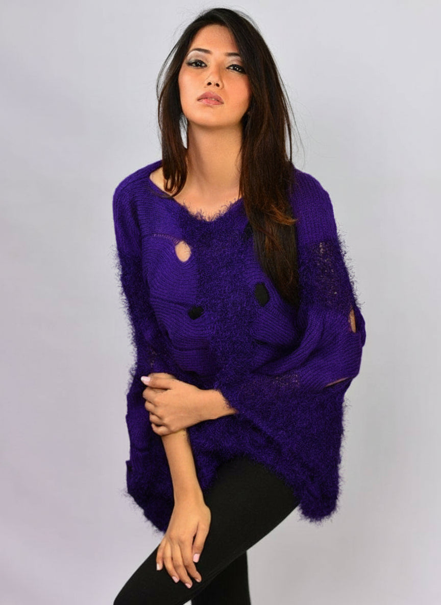 Front styling view of Coastline's Oversize Audrey Sweater in Purple Indigo, paired with black trousers and featuring textured knit details.
